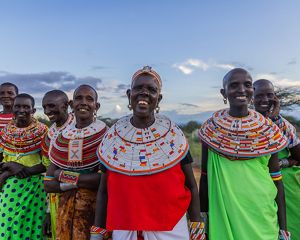 A group of women stand in a line facing the camera.