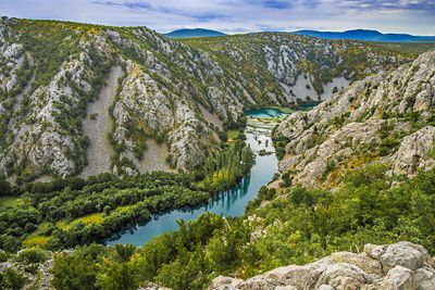 Aerial view of a river winding through a high-walled canyon.