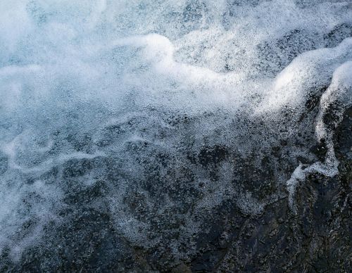 Fast moving water splashes in whitewater rapids.
